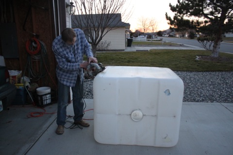 Me cutting the IBC tote, photo by Hannah
