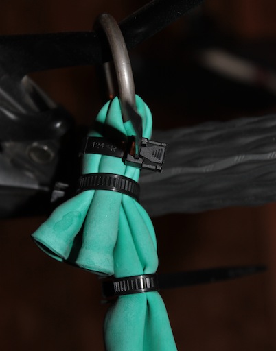 Three reusable zip ties holding a ring in place around the balloon's neck