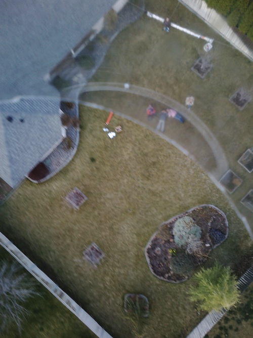 Maiden voyage shot, people laying on ground watching visible blurry through edge of bottle in frame